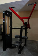 Life Fitness Pro 2 high pull machine with a red and black frame, set in a gym environment with a concrete floor and beige walls.