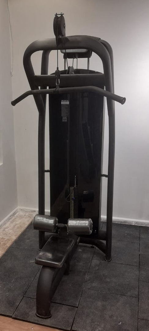 Techno Gym Lat Pulldown machine set on a dark gray rubber mat in a home gym environment.