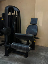 Technogym Leg Extension with adjustable weights, a padded seat, and a leg rest, photographed in our showroom.